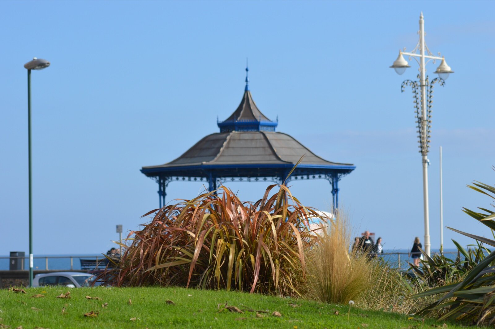 The blue and grey bandstand on the seafront lawns at Bognor Regis, with the sea behind