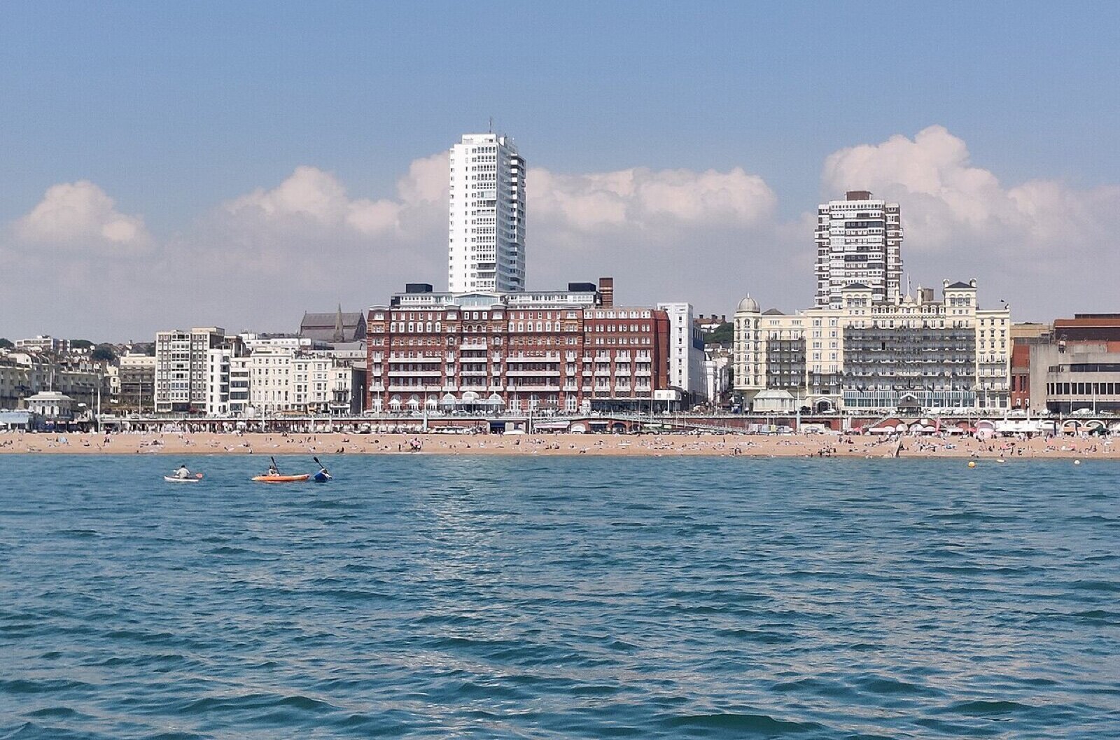 Brighton seafront seen from the sea, with the beach, seafront hotels and Sussex Heights tower behind