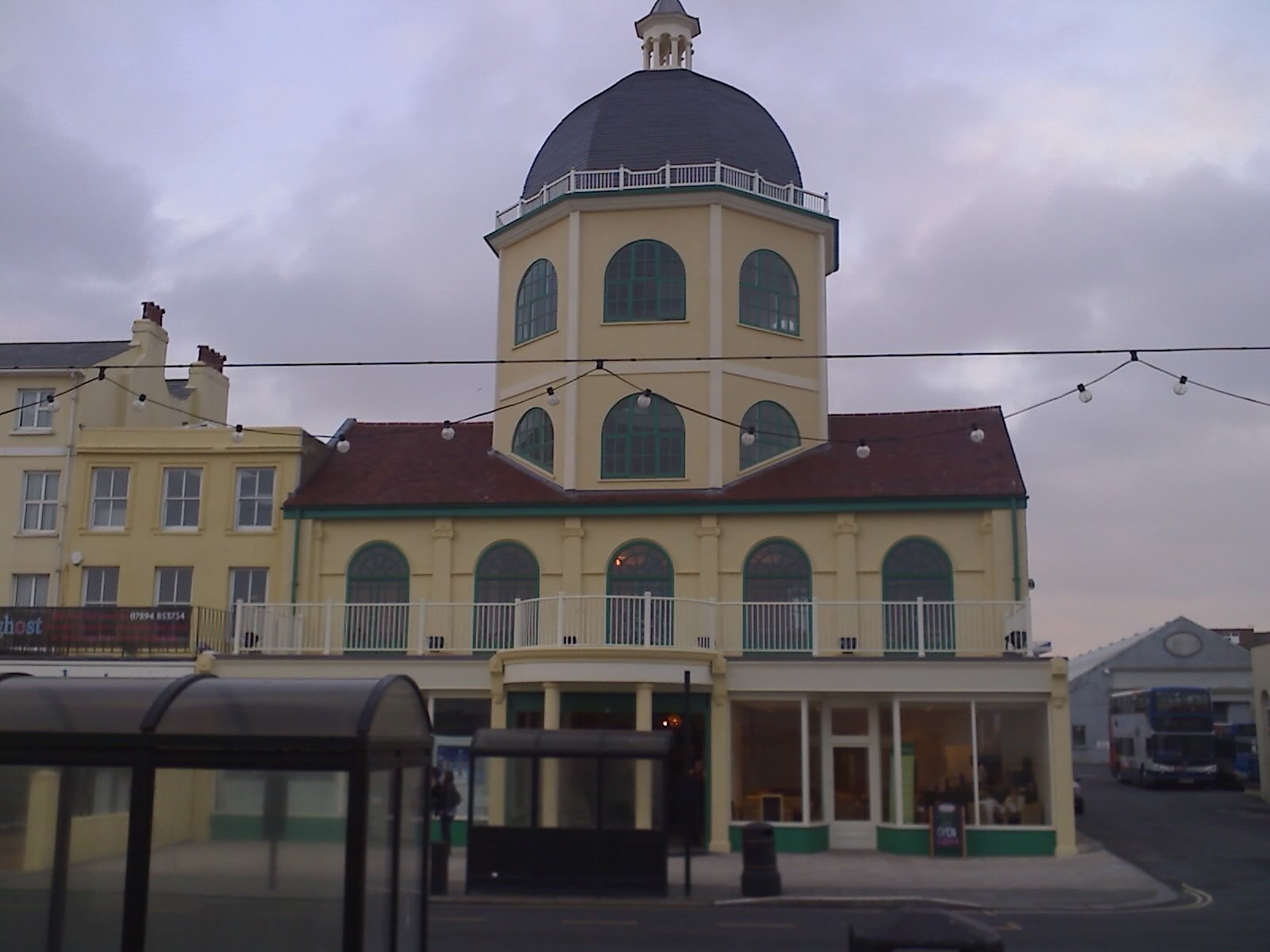 The cream-painted Dome cinema on Worthing seafront, with its octagonal domed tower, arched green windows and a first-floor balcony