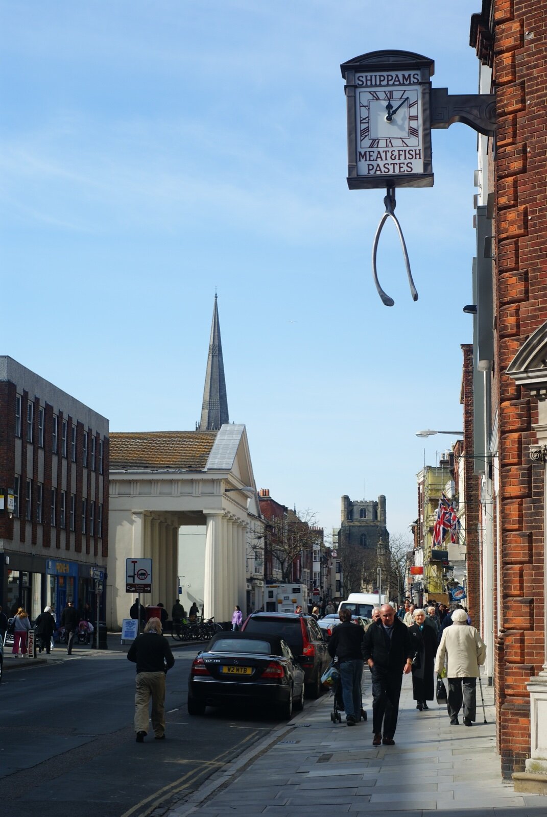 East Street in Chichester with the cathedral spire beyond and the Shippams clock overhead