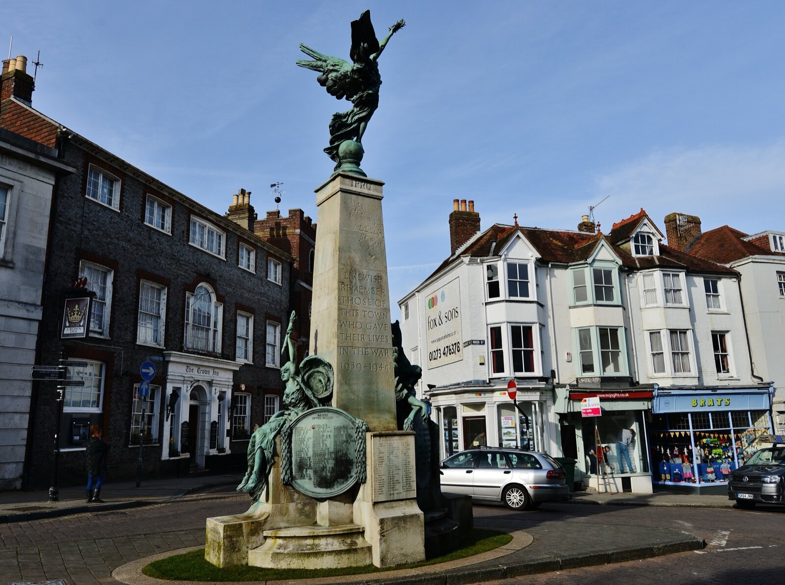Lewes High Street at the war memorial, with Georgian frontages and shops running down towards School Hill