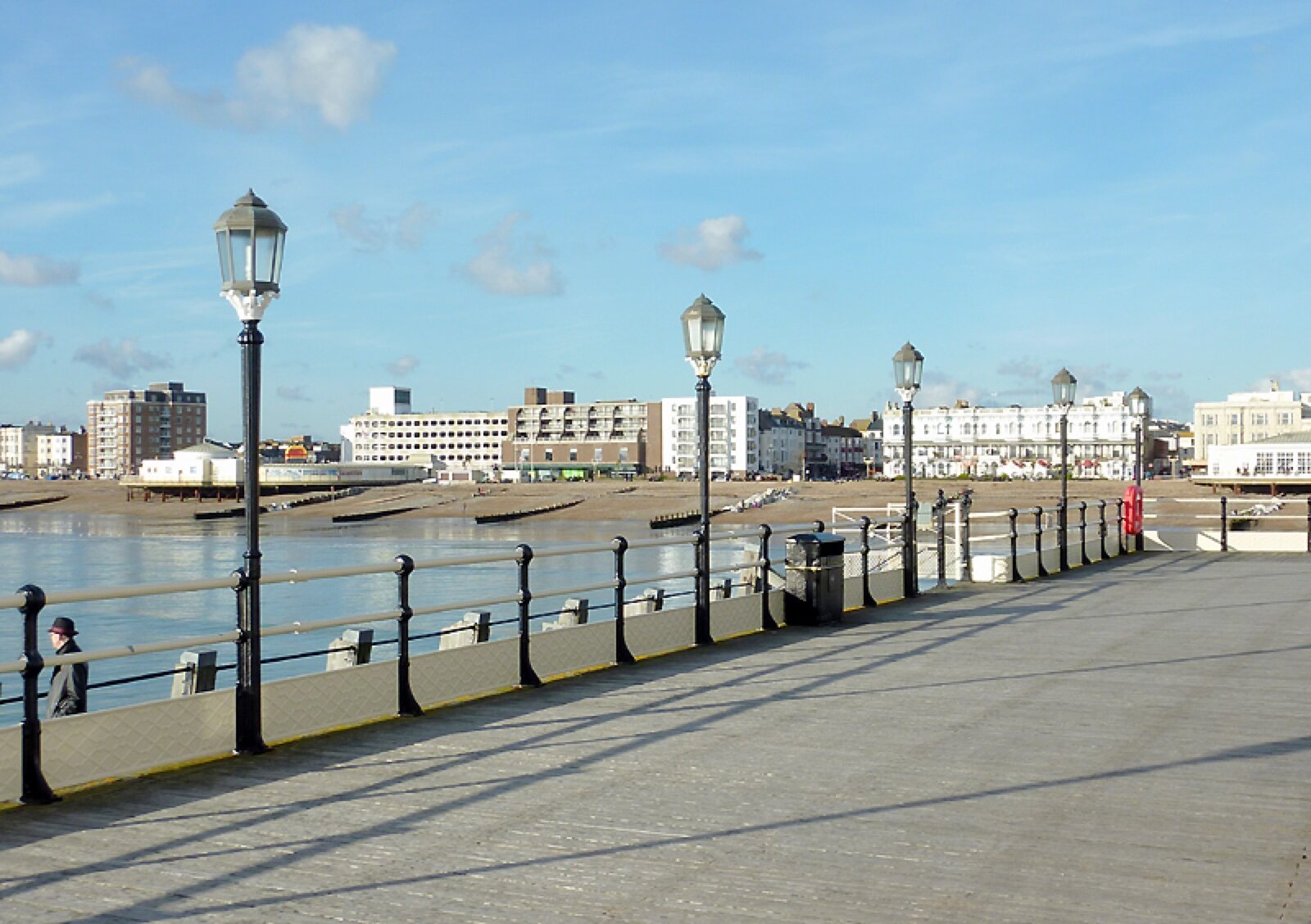 Worthing seafront and the pier promenade, with the town's terraced buildings along the front